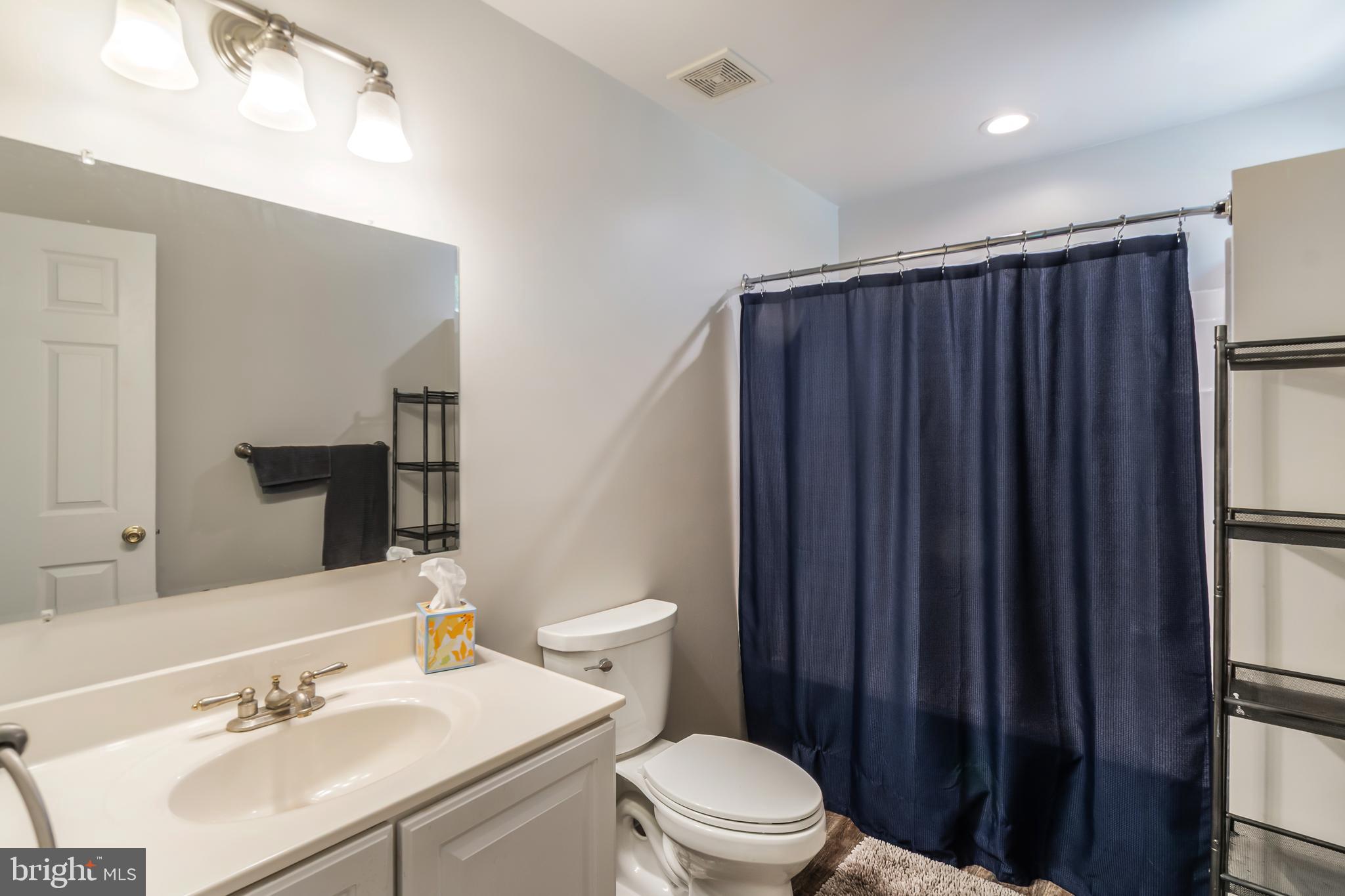 3040 Jones Road Dunkirk, MD 20754 - Photo 50 of 67 a bathroom with a sink a toilet a mirror and shower curtain