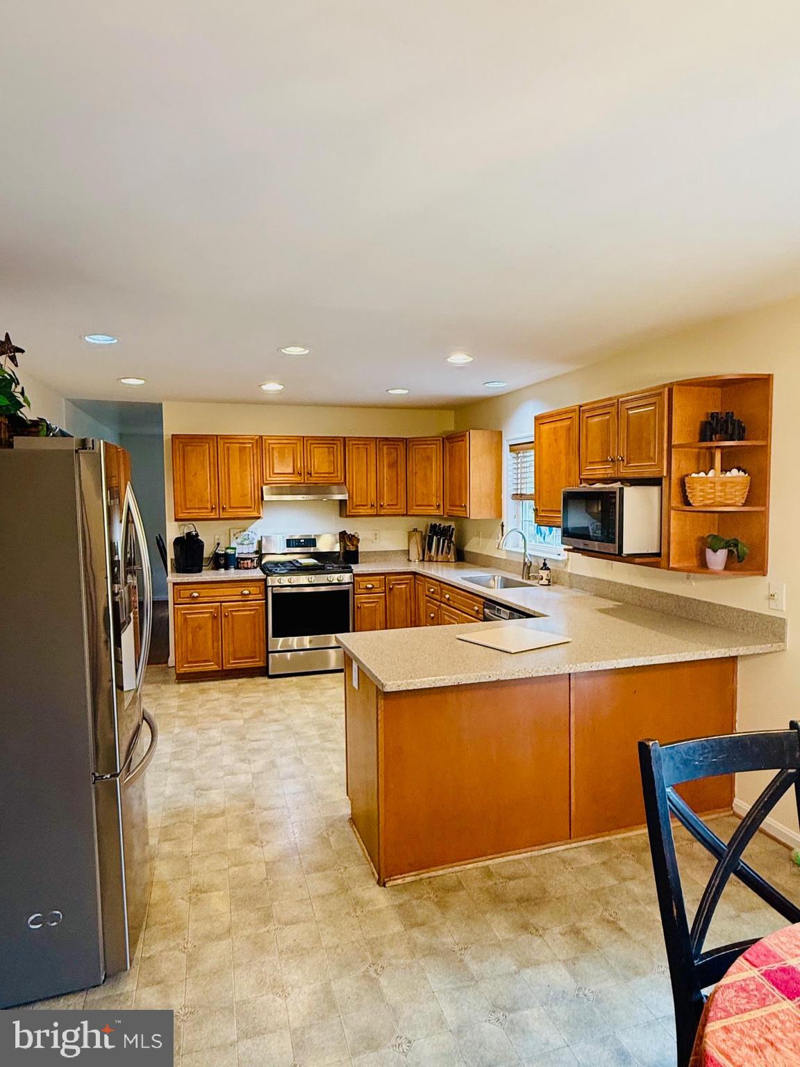 3040 Jones Road Dunkirk, MD 20754 - Photo 5 of 67 a large kitchen with stainless steel appliances granite countertop a stove and a refrigerator