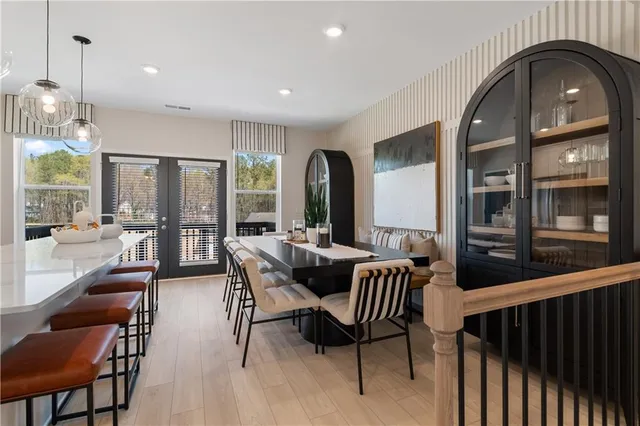 a large white kitchen with stainless steel appliances lots of white cabinets