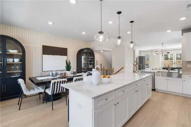 a kitchen with granite countertop white cabinets and white appliances