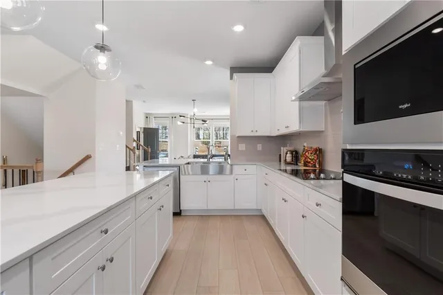 a kitchen with white cabinets and a sink