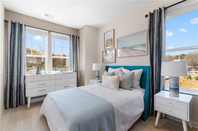 a bedroom with bed and a large window