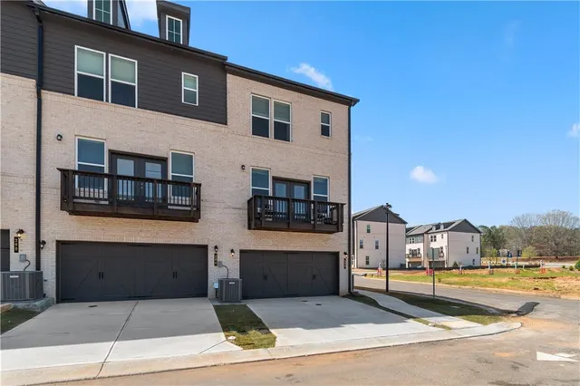 a front view of a residential apartment building with a yard
