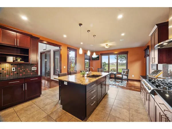 a kitchen with stainless steel appliances granite countertop a stove and a refrigerator