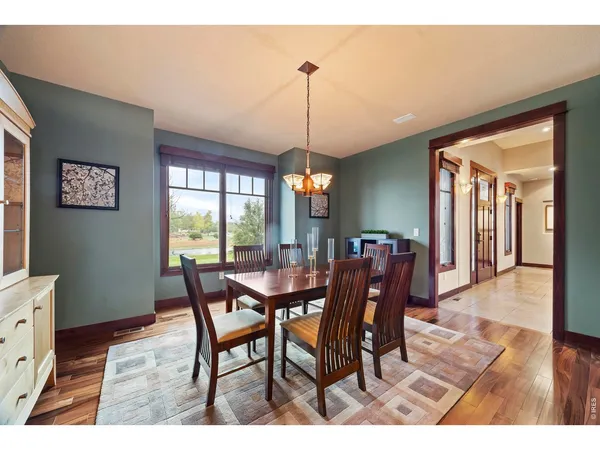 a dining room with furniture window and wooden floor