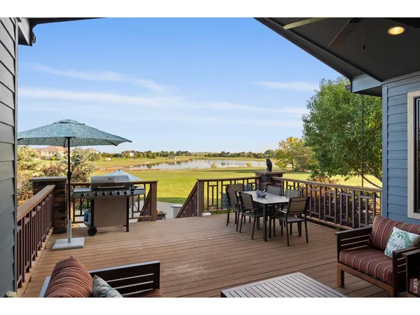 a view of a roof deck with dining table and chairs with wooden floor