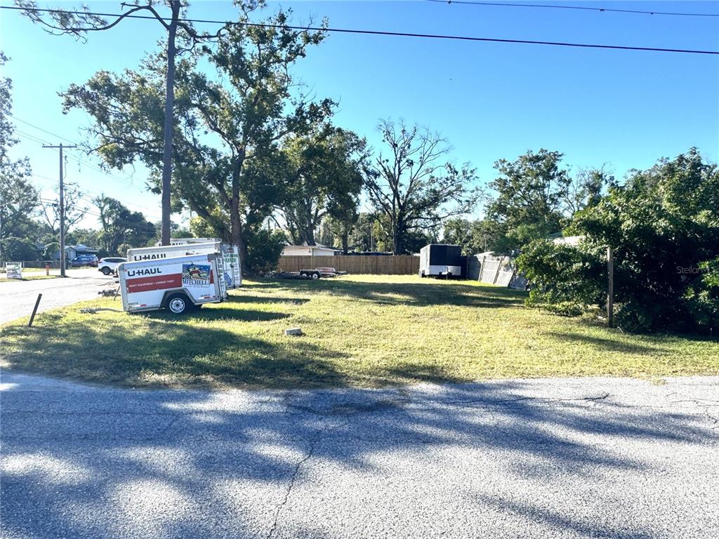 12324 4 Oaks Road Tampa, FL 33624 - Photo 3 of 7 a swimming pool with outdoor seating and yard
