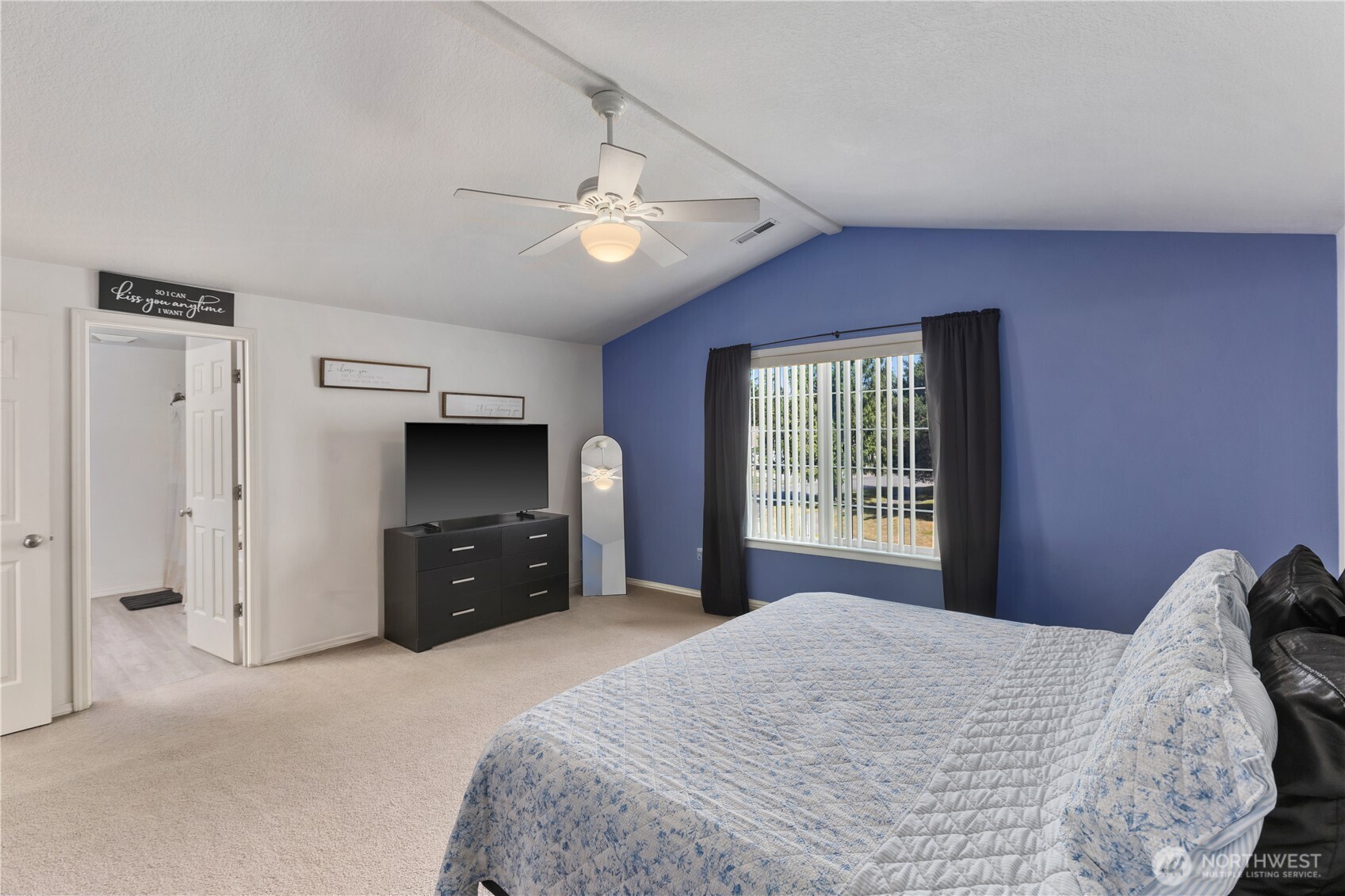 8305 Sweetbrier Loop Southeast Olympia, WA 98513 - Photo 28 of 40 a spacious bedroom with a large bed and a flat tv screen on dresser