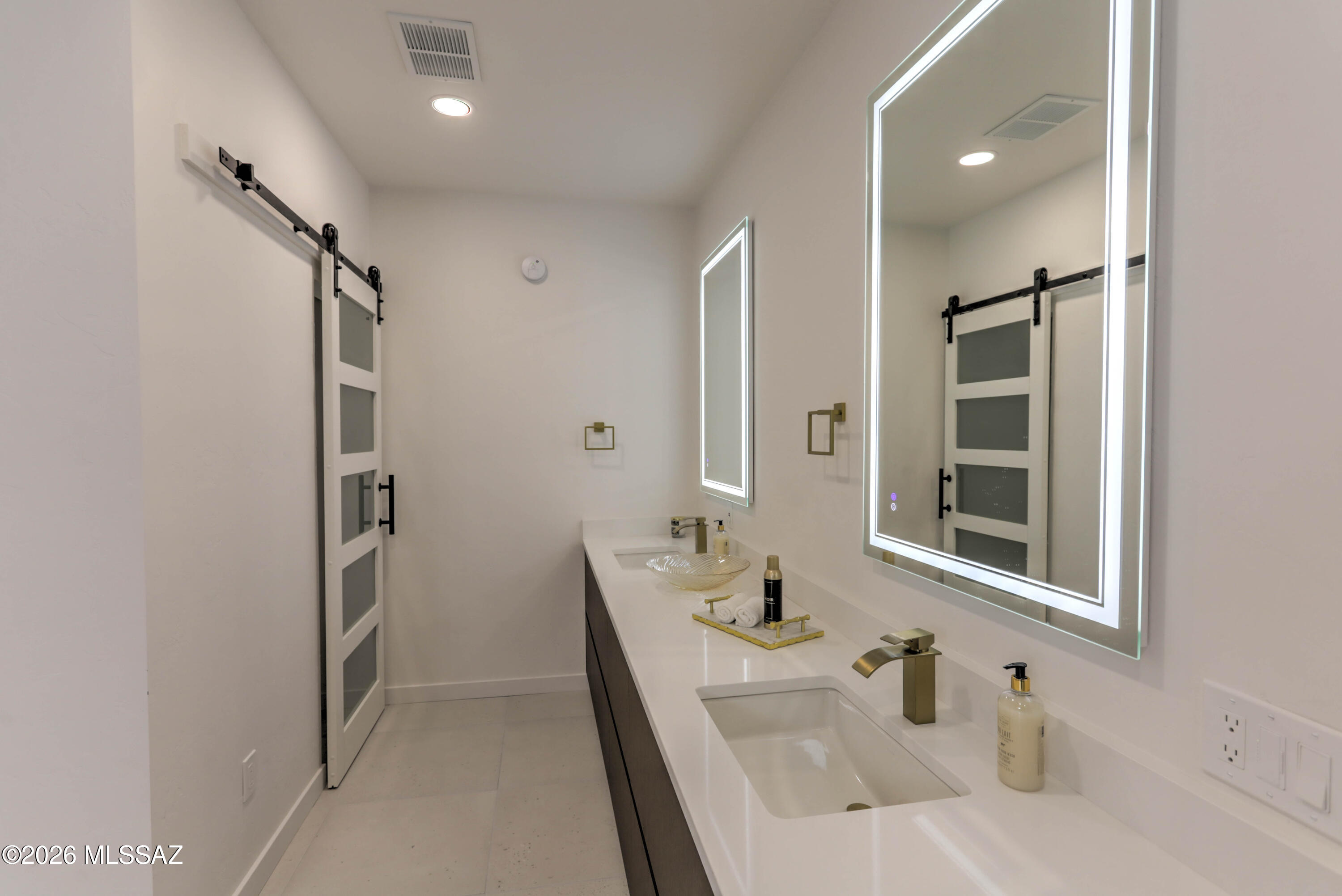 4939 East River Road Tucson, AZ 85718 - Photo 16 of 29 a bathroom with a sink and a mirror