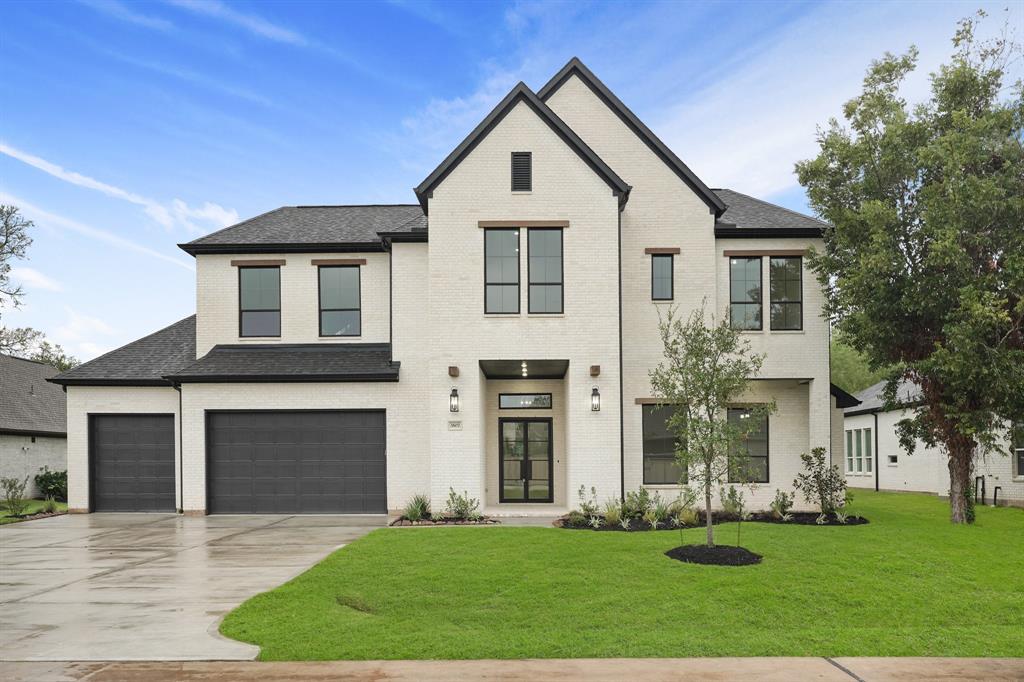 Welcome home through the imposing iron double doors, setting the tone for elegance and bespoke touches. The towering front porch, TRUE WHITE king-size brick, and wood accents create a commanding curb appeal that is truly inviting.