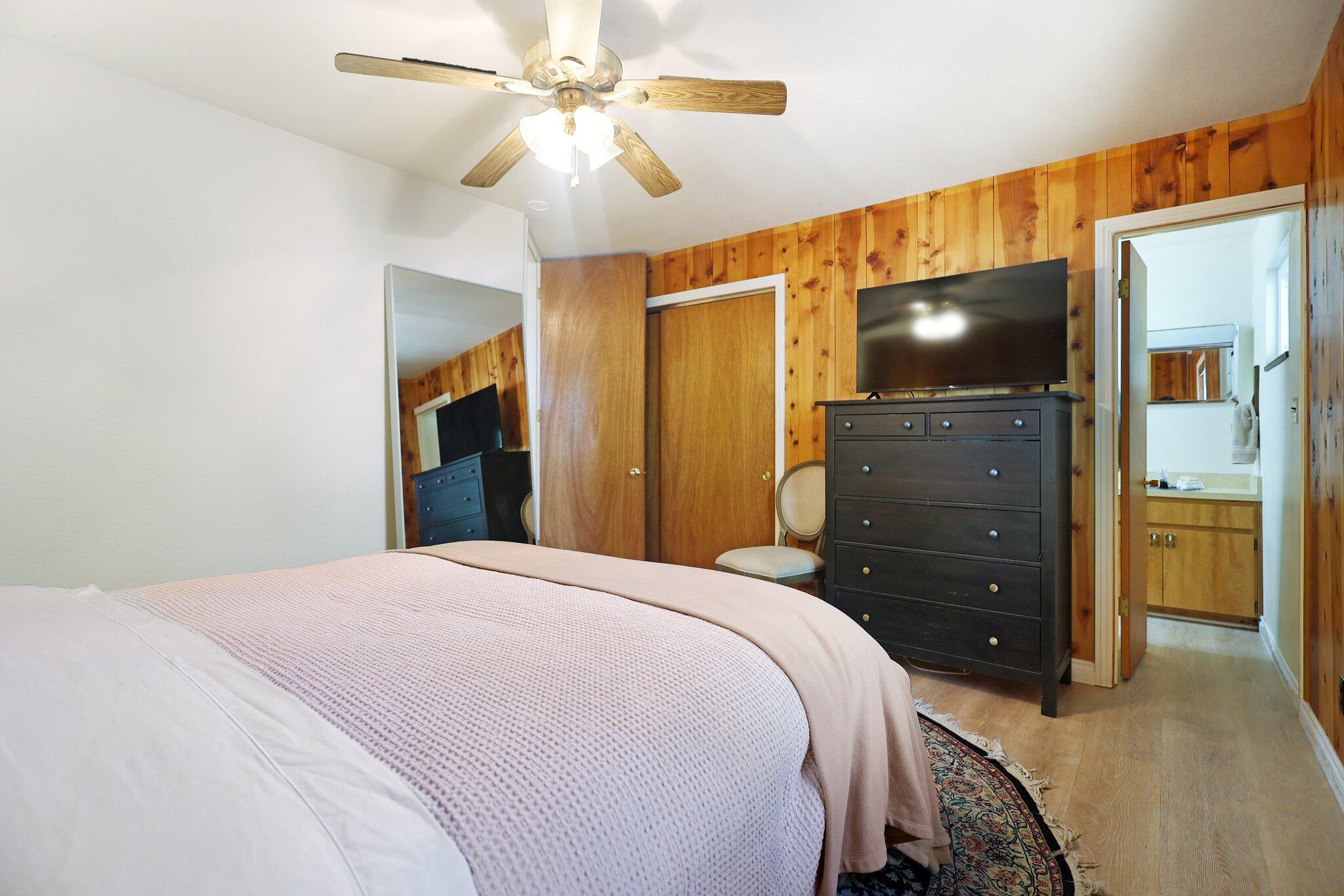 21800 Cedar Ridge Road Manton, CA 96059 - Photo 14 of 35 a bedroom with a bed and a flat tv screen on dresser