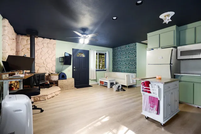 a kitchen with stainless steel appliances granite countertop a refrigerator a sink dishwasher a stove and a refrigerator