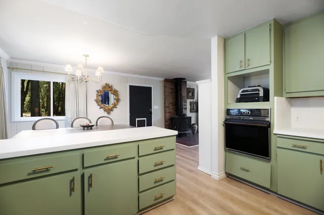 a kitchen with a table chairs stove and refrigerator