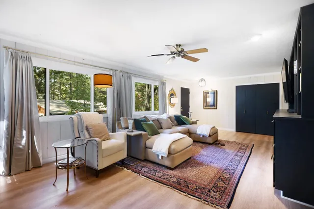 a living room with furniture and a wooden floor