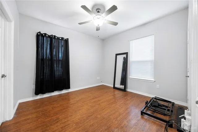 a view of livingroom with hardwood floor and a ceiling fan