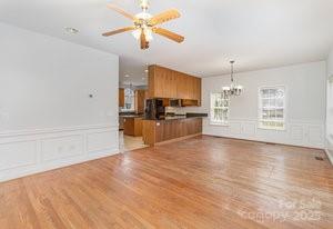 836 Brookfield Circle Salisbury, NC 28146 - Photo 22 of 42 a view of a kitchen with a stove cabinets wooden floor and a ceiling fan