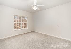 836 Brookfield Circle Salisbury, NC 28146 - Photo 26 of 42 an empty room with a window and a ceiling fan