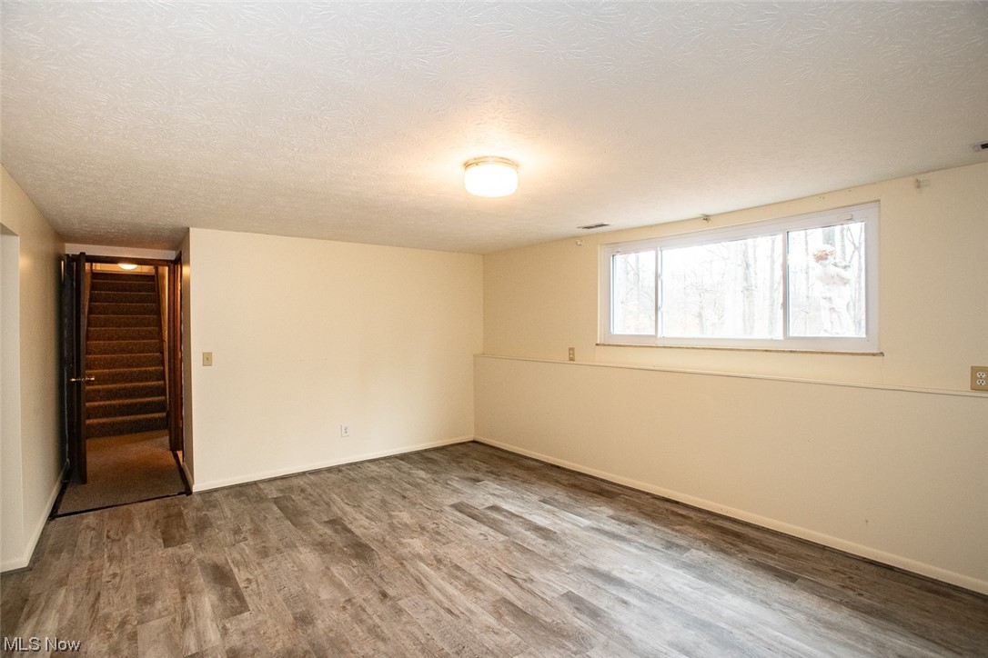 14358 Prospect Road Strongsville, OH 44149 - Photo 28 of 35 Empty room featuring a textured ceiling and hardwood / wood-style floors