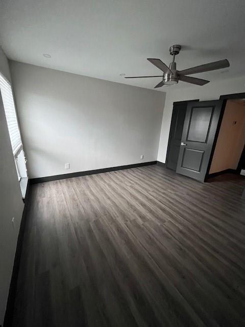 7734 Meadow Road, Unit 117 Dallas, TX 75230 - Photo 12 of 15 Unfurnished bedroom featuring dark wood-style flooring and ceiling fan