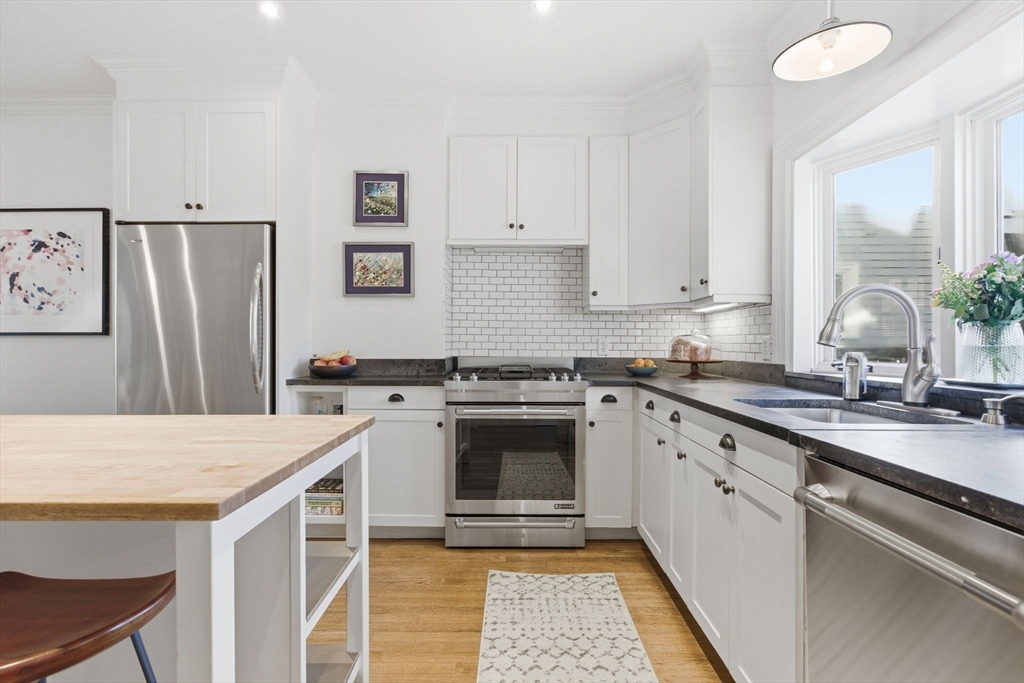 38 Bartlett Street Boston, MA 02129 - Photo 6 of 37 a kitchen with a stove a sink and a refrigerator