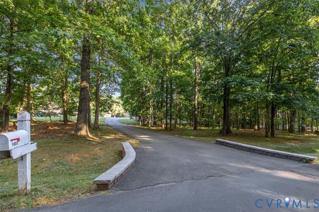 1437 Palmore Road Powhatan, VA 23139 - Photo 4 of 60 Asphalt driveway framed by mature trees and a low
