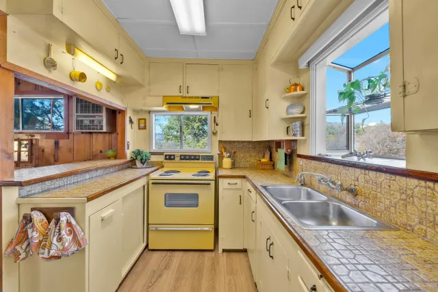 a kitchen that has a sink and a stove