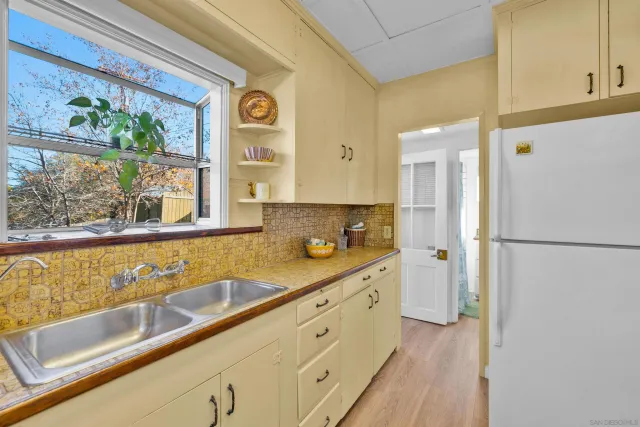 a spacious bathroom with a granite countertop sink and a window