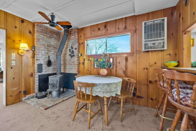 a dining room filled with furniture and a window