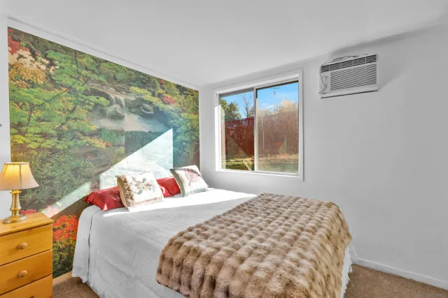 a bedroom with a bed and a window