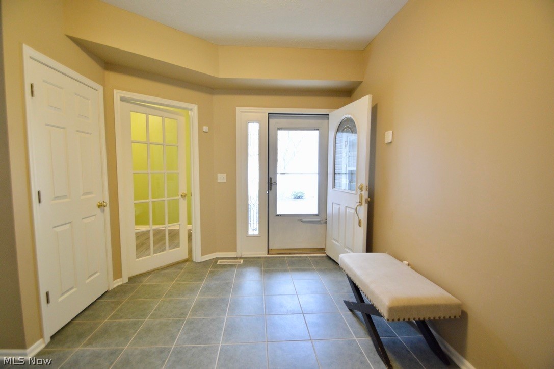 30247 Center Ridge Road, Unit 12 Westlake, OH 44145 - Photo 4 of 35 Foyer with coat closet and glass door to private office/den