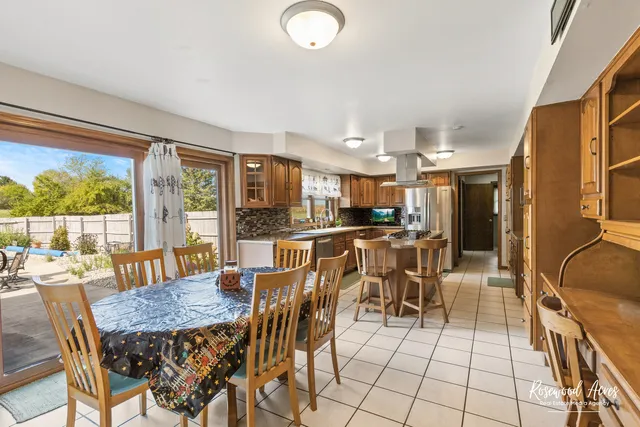 a kitchen with stainless steel appliances a stove a sink dishwasher and cabinets with wooden floor