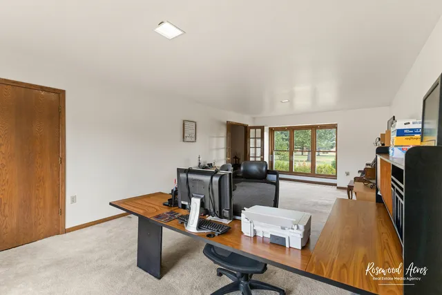 a spacious bedroom with two beds and large windows