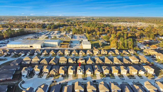 an aerial view of residential houses with outdoor space and swimming pool