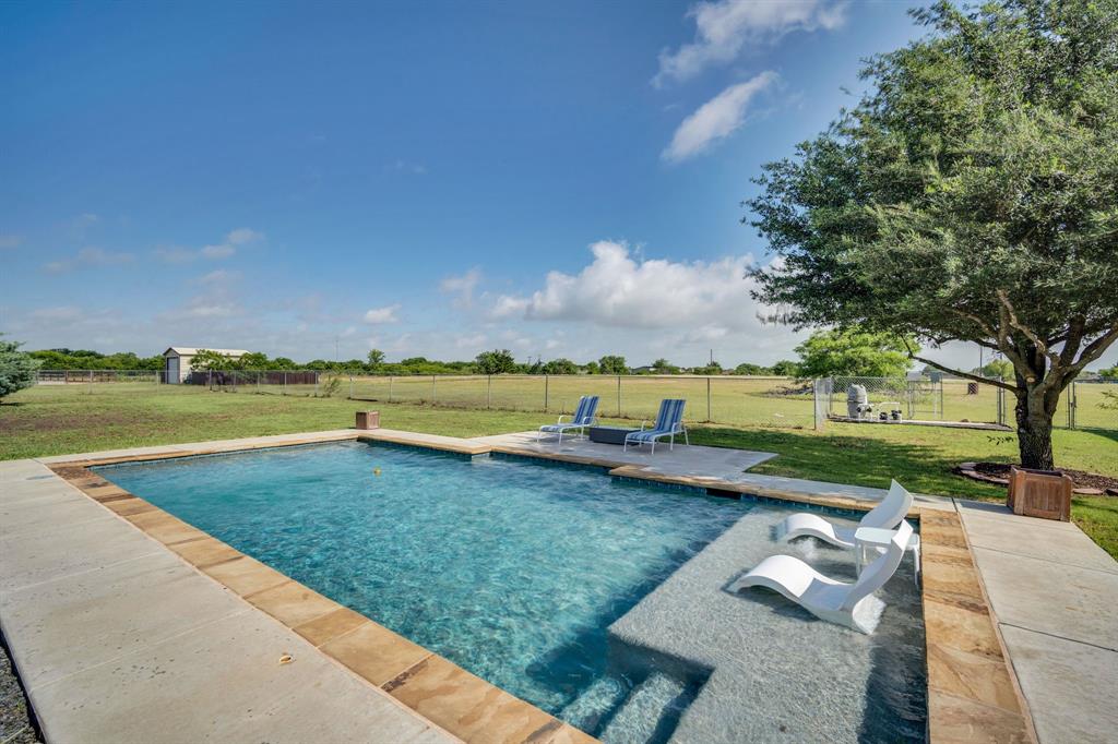 431 Mc Alpin Road Midlothian, TX 76065 - Photo 8 of 18 Rectangular inground pool featuring a baja shelf with two built-in loungers, concrete decking, and natural stone coping