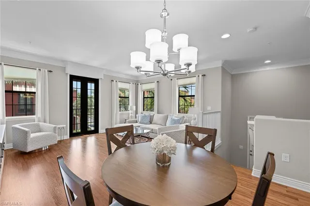 a view of a dining room with furniture wooden floor and chandelier
