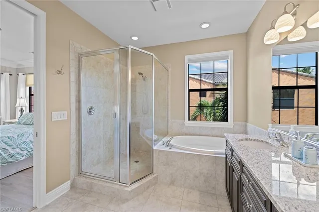 a spacious bathroom with a granite countertop tub shower and sink