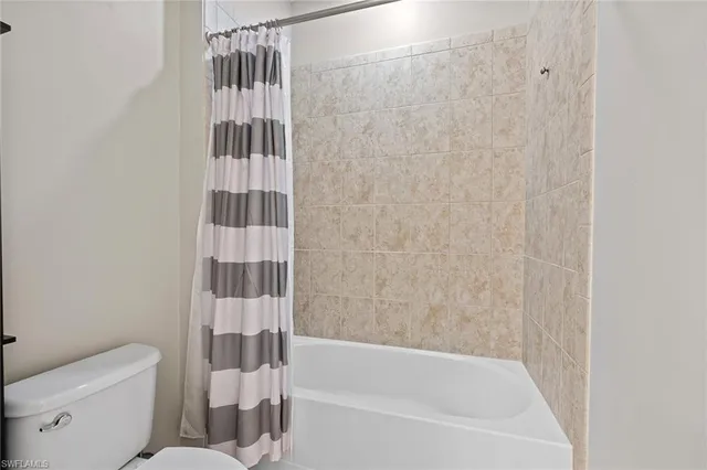 a bathroom with a bathtub and a toilet