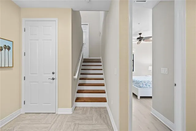 a view of a hallway with wooden floor and entryway