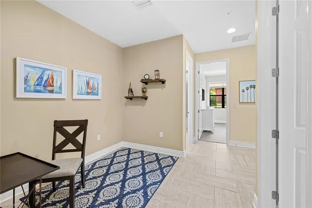 a view of a hallway to a livingroom with furniture and wooden floor