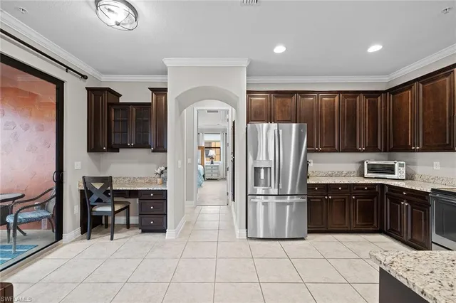 a kitchen with granite countertop a refrigerator and a sink