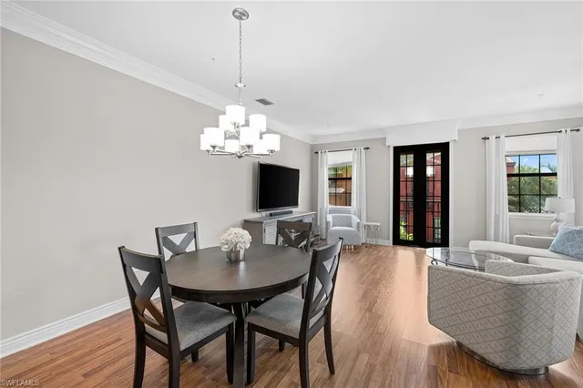 a view of a dining room with furniture and chandelier