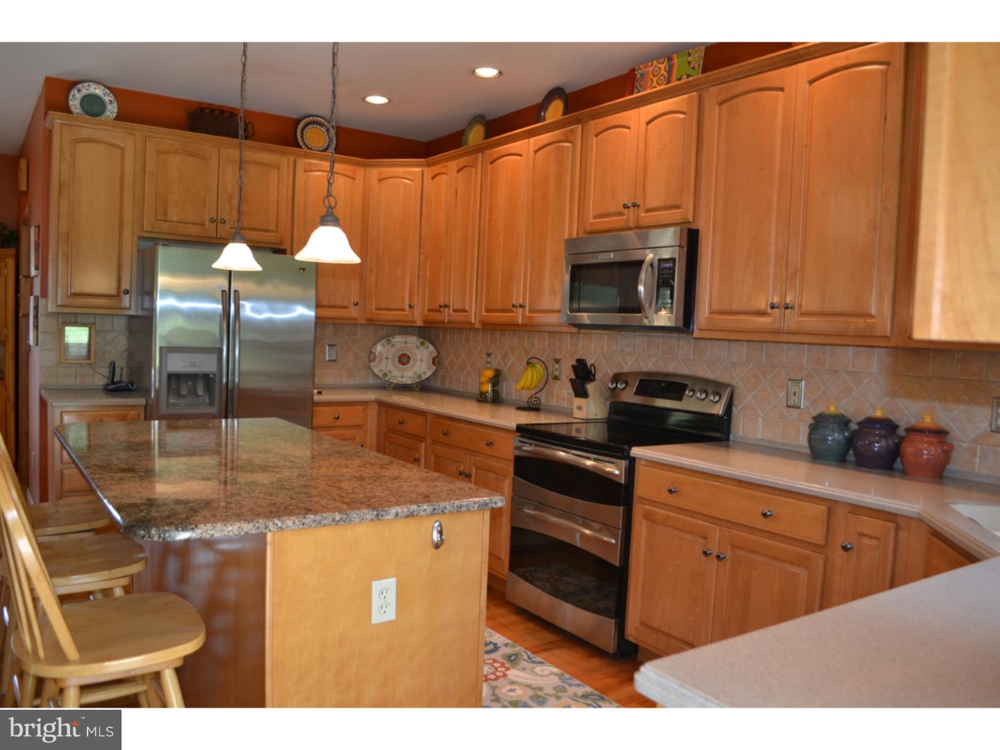 1011 Bucks Road Perkasie, PA 18944 - Photo 3 of 25 a kitchen with stainless steel appliances granite countertop a sink a stove cabinets and a dining table