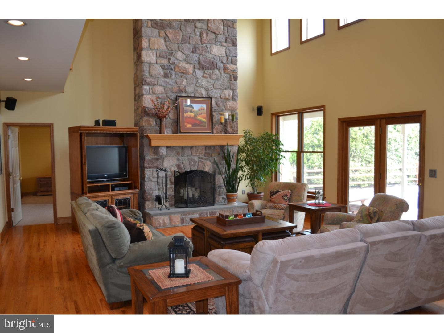 1011 Bucks Road Perkasie, PA 18944 - Photo 7 of 25 a living room with furniture a flat screen tv and a fireplace