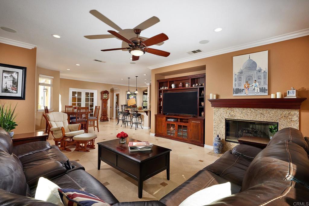 962 Baylor Drive San Marcos, CA 92078 - Photo 13 of 40 a living room with furniture a flat screen tv and a fireplace