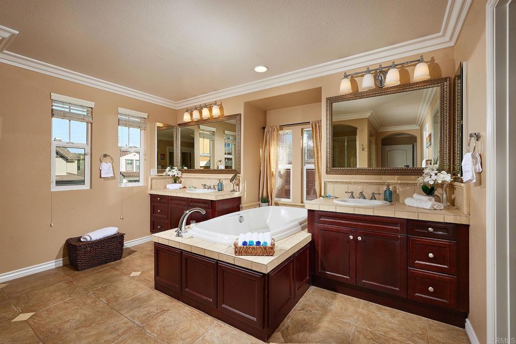 962 Baylor Drive San Marcos, CA 92078 - Photo 22 of 40 a spacious bathroom with a tub double vanity and a mirror