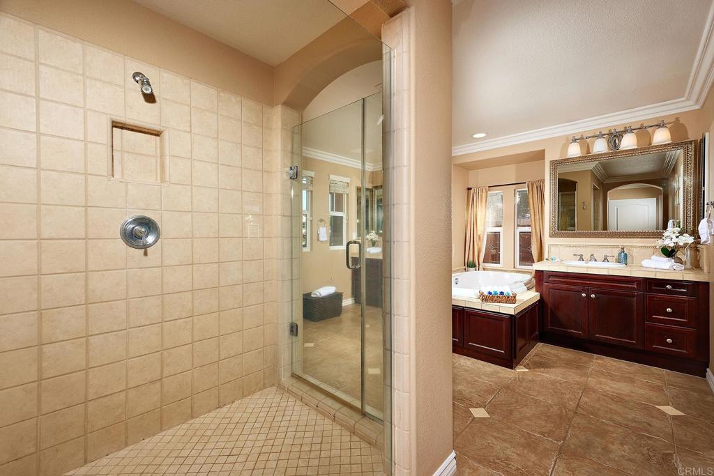 962 Baylor Drive San Marcos, CA 92078 - Photo 23 of 40 a bathroom with a sink a large mirror and a shower