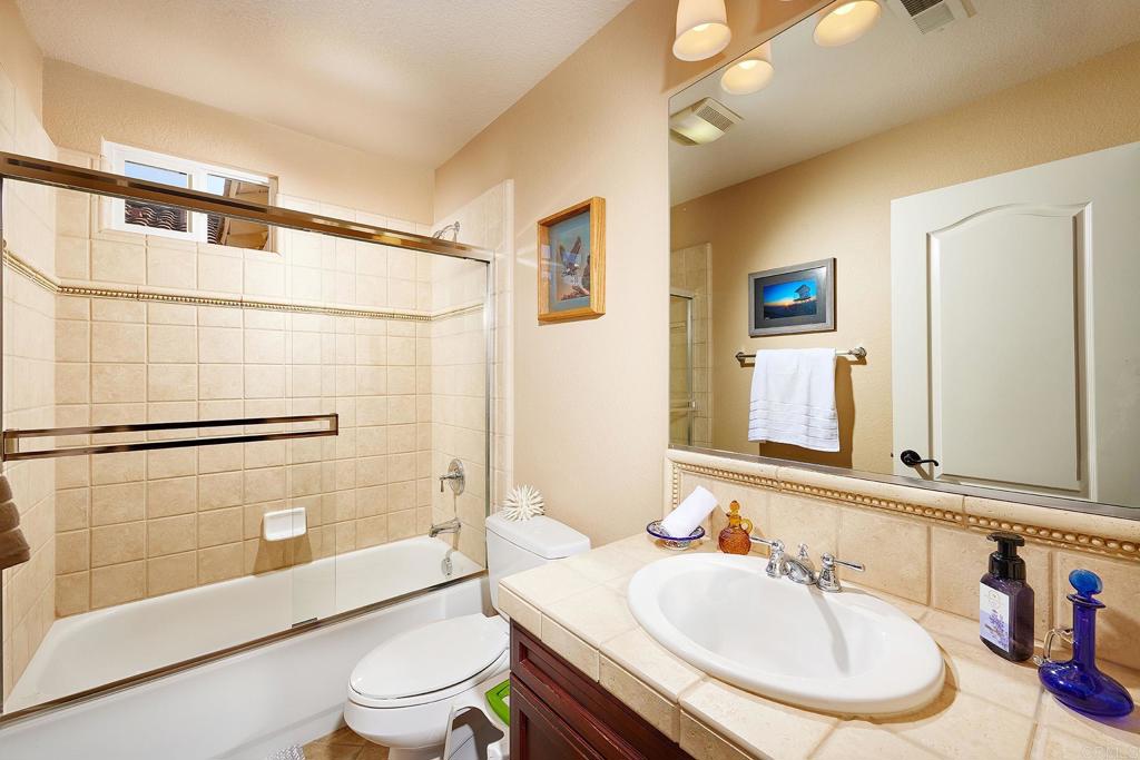 962 Baylor Drive San Marcos, CA 92078 - Photo 27 of 40 a bathroom with a sink toilet and shower