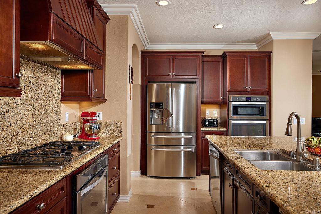 962 Baylor Drive San Marcos, CA 92078 - Photo 10 of 40 a kitchen with granite countertop a refrigerator stove and sink