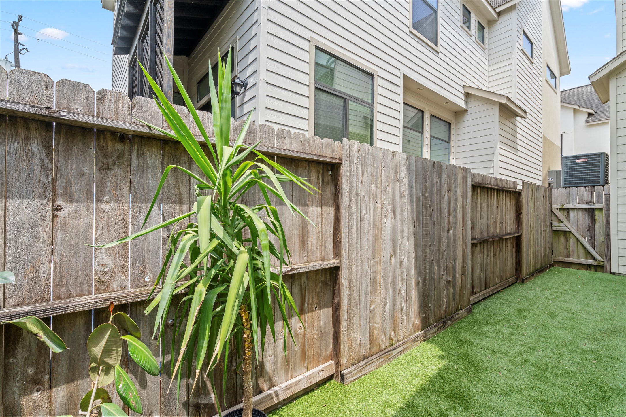 2609 Riverside Drive, Unit E Houston, TX 77004 - Photo 23 of 25 Fully fenced and turfed, the backyard offers space for pets, play, or small seating area.