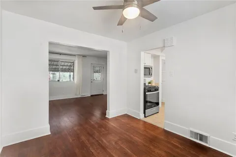 a spacious bathroom with a granite countertop sink and a mirror